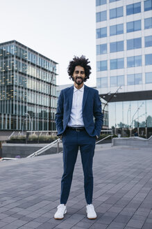 Spain, Barcelona, portrait of stylish young businessman standing in the city - JRFF02071