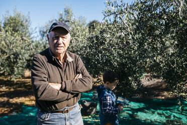 Porträt eines älteren Mannes mit seinem Enkel in einem Olivenhain - JRFF02122