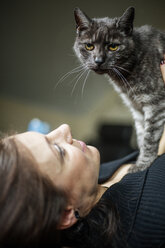 Porträt einer grau getigerten Katze und ihres Besitzers zu Hause - JATF01062