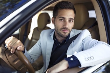 Successful young businessman driving in his car - JSRF00095