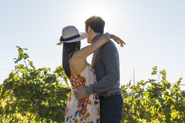 Italy, Tuscany, Siena, young couple embracing in a vineyard - FBAF00201