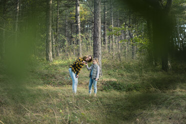 Mother and daughter exploring nature in the forest - MOEF01655