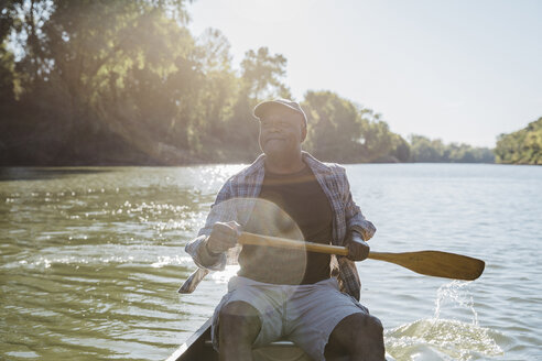 Man rowing on lake against sky - CAVF56279