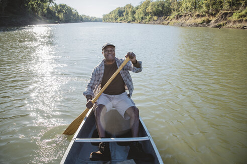 Portrait of smiling man rowing on lake - CAVF56280