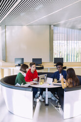 Friends discussing while studying in library - CAVF56341