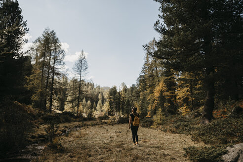 Switzerland, Engadin, woman on a hiking trip in forest - LHPF00130