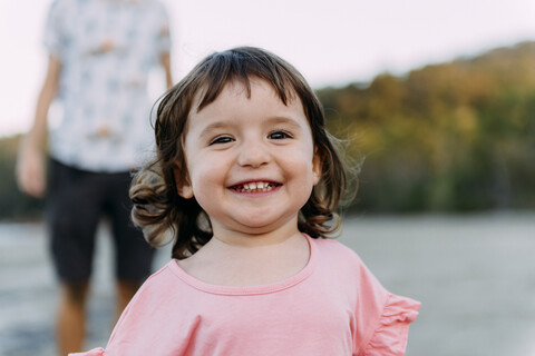 Australia, Queensland, Mackay, Cape Hillsborough National Park, portrait of happy little girl with her father at the beach stock photo