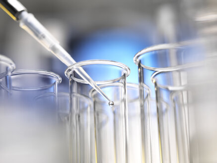 Scientist pipetting a sample into a test tube during a experiment in the laboratory - ABRF00249