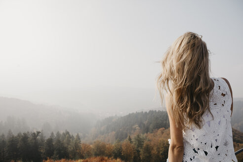 Germany, Black Forest, Sitzenkirch, young woman looking at view in mountain forest - LHPF00165