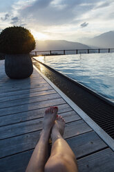 Woman relaxing at the poolside - LHPF00175