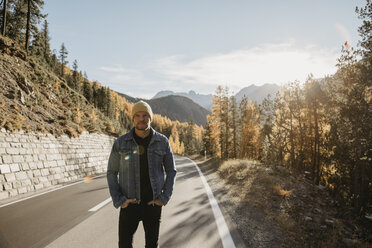 Man travelling through Switzerland, standing on road - LHPF00184