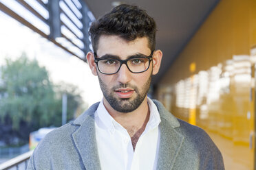 Portrait of young bearded businessman wearing glasses - TCF05979