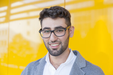 Portrait of smiling young businessman wearing glasses - TCF05980