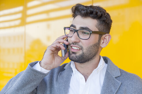 Portrait of bearded young businessman on the phone - TCF05981