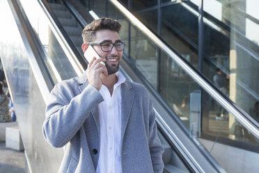 Portrait of smiling young businessman on the phone - TCF05982