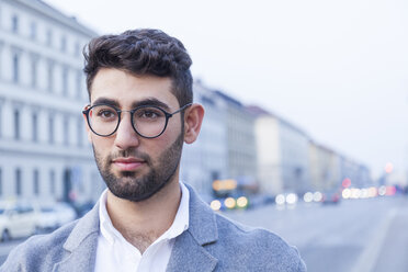 Portrait of bearded young businessman wearing glasses - TCF05995