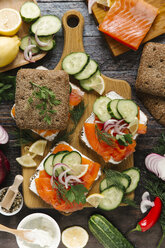 Close-up of salmon and vegetables sandwich on cutting board - CAVF56446