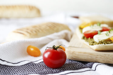 Close-up of panini served on cutting board with napkin on table - CAVF56450