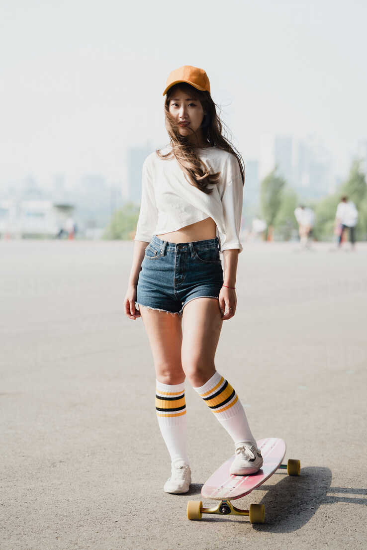 Skater Girl at Skatepark. Full-Length Portrait of Female Hipster
