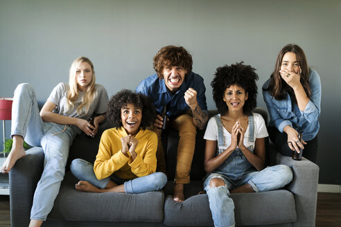 Nervous friends sitting on couch watching tv - VABF01915