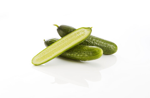 Whole and sliced cucumber stock photo