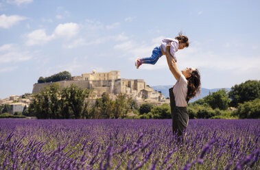 France, Grignan, mother and little daughter having fun together in lavender field - GEMF02593