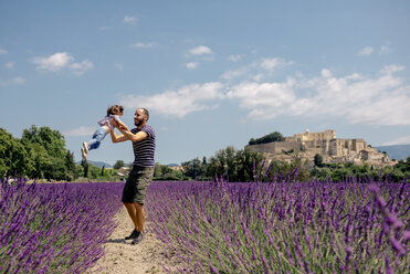 France, Grignan, father and little daughter having fun together in lavender field - GEMF02600