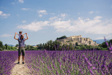 France, Grignan, father standing on foot path between lavender fields with little daughter on his shoulders - GEMF02601