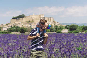 France, Grignan, father and little daughter having fun together in lavender field - GEMF02613