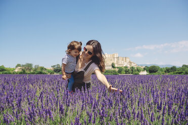 France, Grignan, mother and little daughter having fun together in lavender field - GEMF02620