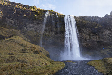 Scenic view of Seljalandsfoss Waterfall over mountain against sky - CAVF56830