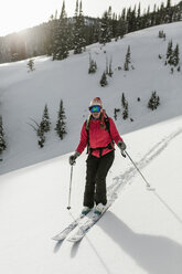 Woman skiing on snow covered mountain at forest - CAVF56867