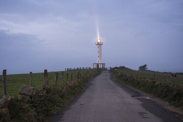 Illuminated lighthouse against cloudy sky during dusk - CAVF57023