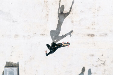 Overhead view of man skateboarding on footpath - CAVF57061