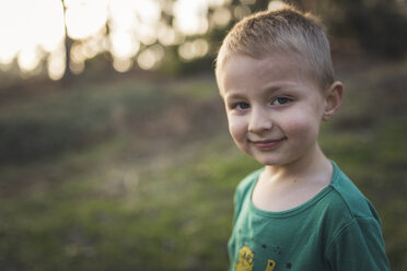 Close-up portrait of cute boy standing at park - CAVF57118