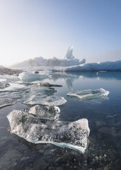 Scenic view of icebergs with ice floating on sea against clear sky during winter - CAVF57174