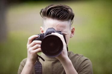 Close-up of teenage boy photographing - CAVF57332