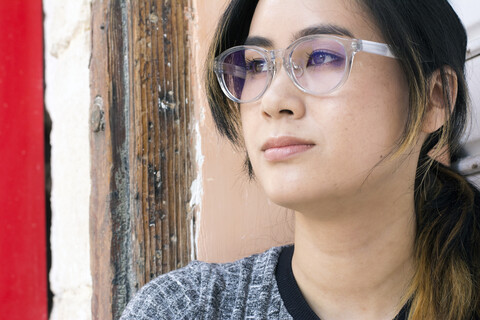 Portrait of young woman wearing fashionable glasses stock photo