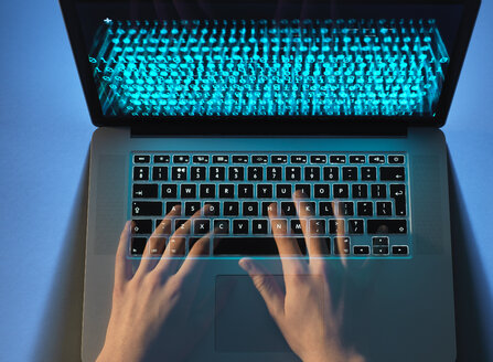 Hands of hacker coding computer virus on laptop - ABRF00257