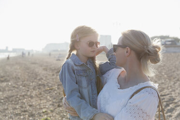 Mother and daughter wearing sunglasses on sunny beach - CAIF22253