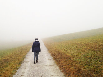 Woman walking in fog - WWF04499