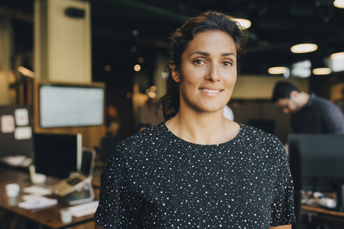 Portrait of confident businesswoman smiling in creative office - MASF09942