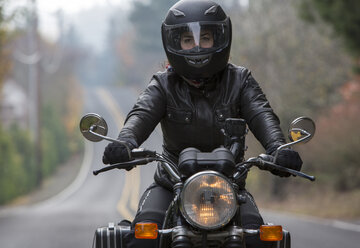 Three men wearing open face crash helmets and goggles riding cafe racer  motorcycles along rural road Stock Photo - Alamy