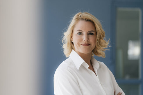 Portrait of confident blond woman wearing white shirt - KNSF05405