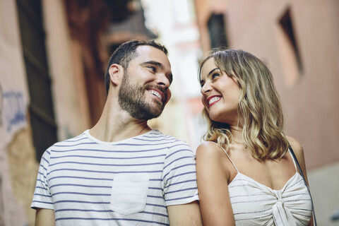 Spain, Andalusia, Malaga, happy tourist couple looking at each other in the city stock photo