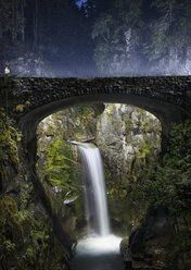 Scenic view of waterfall seen through bridge at Mt Rainier National Park - CAVF57816