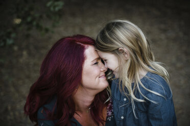 Playful mother and daughter rubbing noses - CAVF57847