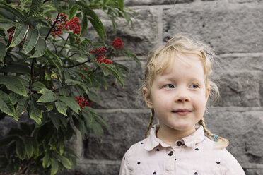 Cute girl looking away against wall - CAVF57933