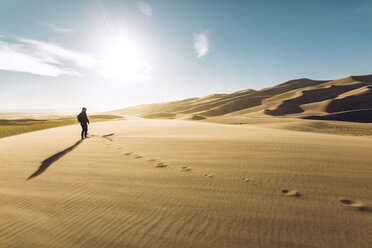 Hiker on sand at Great Sand Dunes National Park during sunny day - CAVF57939