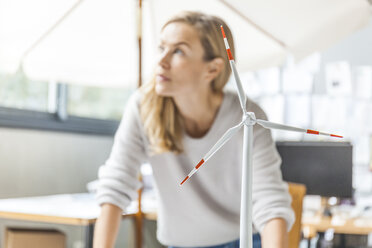 Woman in office working on wind turbine model - TCF06014